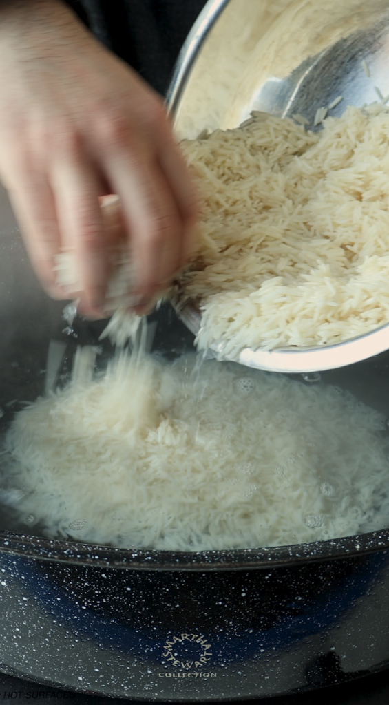 While this is cooking, boil water in a large Dutch oven for basmati rice, parboil the rice, and drain. 